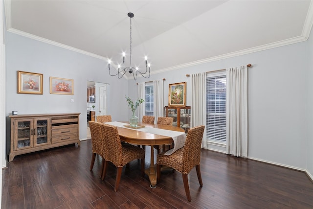 dining area with vaulted ceiling, ornamental molding, dark hardwood / wood-style floors, and a chandelier