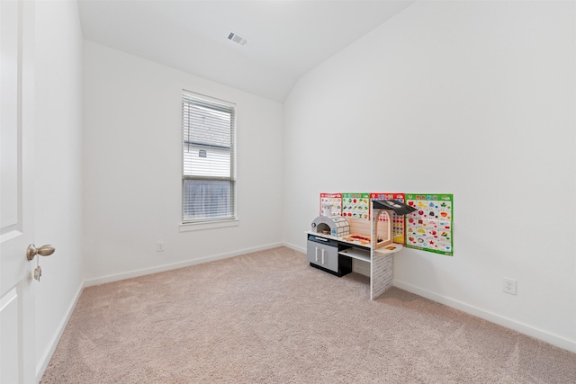 recreation room featuring light carpet, baseboards, visible vents, and vaulted ceiling