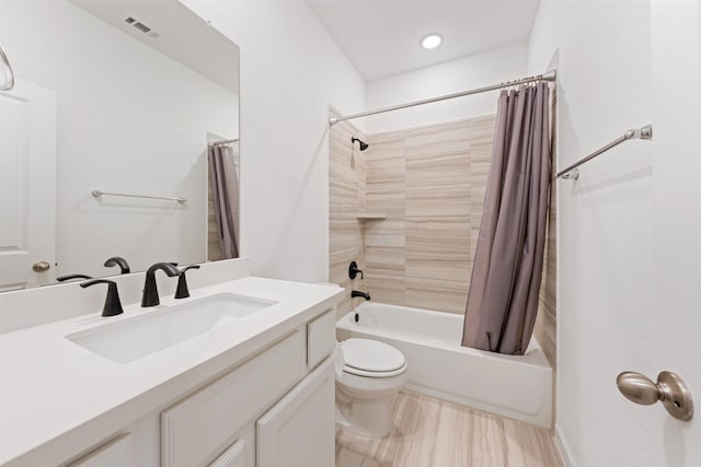 bathroom featuring toilet, shower / tub combo, visible vents, and vanity