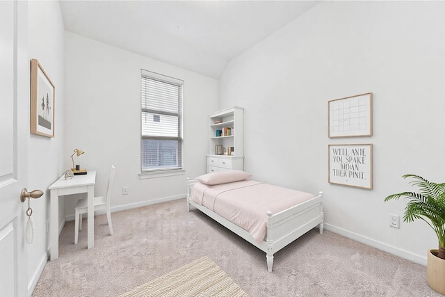 carpeted bedroom featuring lofted ceiling and baseboards