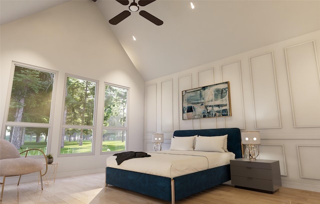 bedroom featuring high vaulted ceiling, ceiling fan, and light wood-type flooring