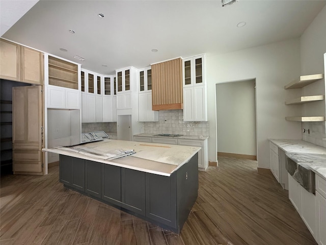 kitchen featuring white cabinetry, dark hardwood / wood-style flooring, black gas cooktop, and a kitchen island