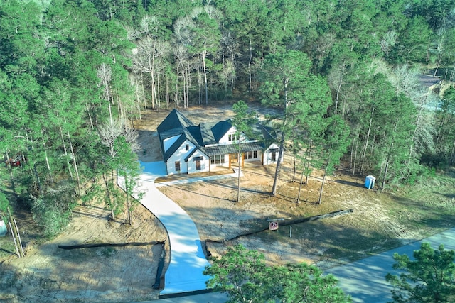 drone / aerial view featuring a forest view