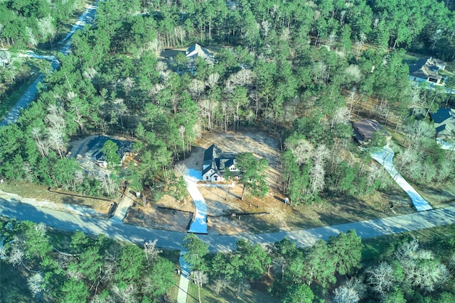 drone / aerial view with a wooded view