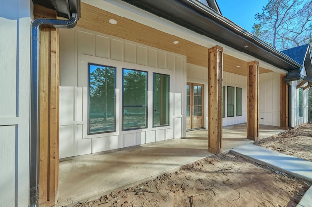 entrance to property featuring a patio area and board and batten siding