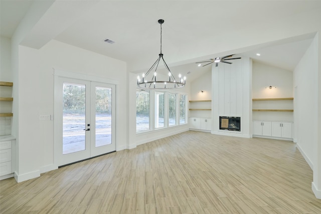 unfurnished living room with visible vents, lofted ceiling, light wood-style flooring, a fireplace, and french doors