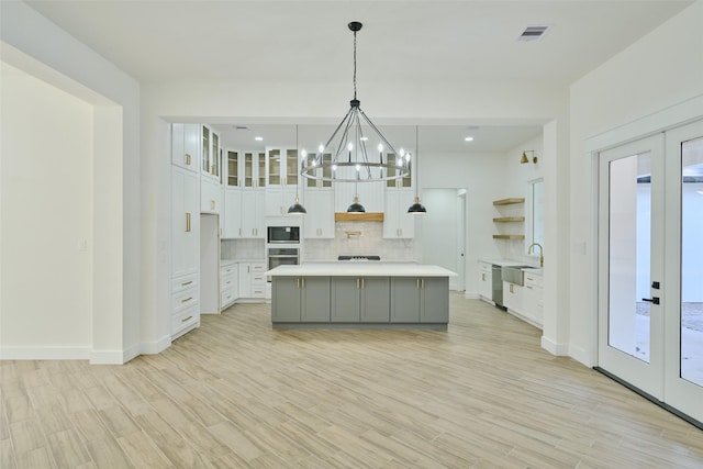 kitchen with visible vents, backsplash, french doors, appliances with stainless steel finishes, and light countertops