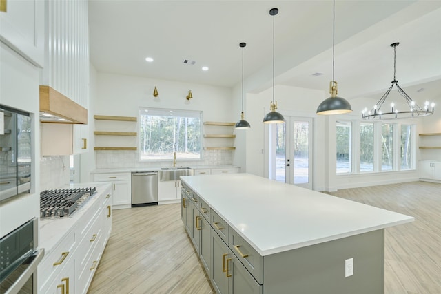 kitchen featuring open shelves, gray cabinetry, light countertops, appliances with stainless steel finishes, and backsplash