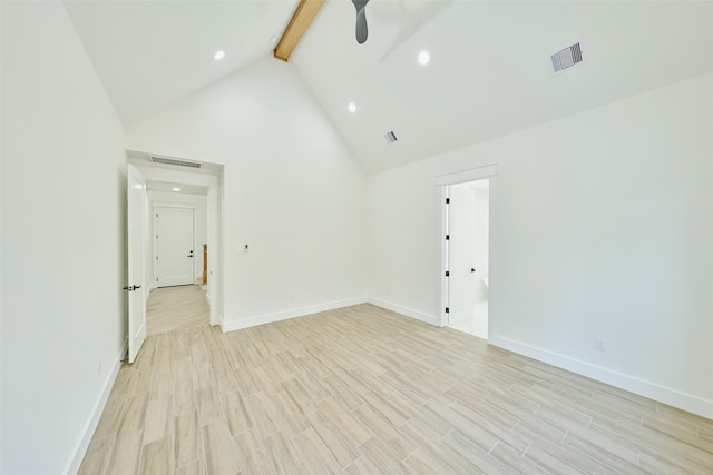 unfurnished room featuring visible vents, beam ceiling, light wood-style floors, and high vaulted ceiling