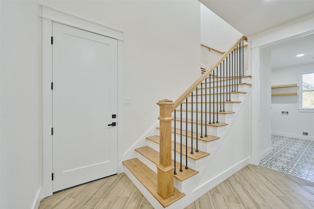 stairs with baseboards and wood tiled floor