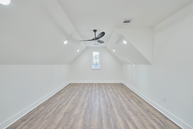 bonus room featuring visible vents, baseboards, lofted ceiling, wood finished floors, and a ceiling fan