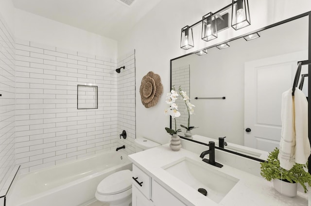 full bathroom featuring vanity, toilet, and tiled shower / bath