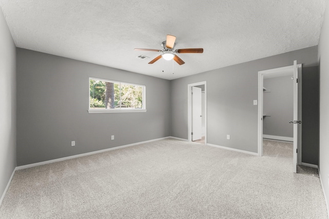 carpeted spare room with a textured ceiling