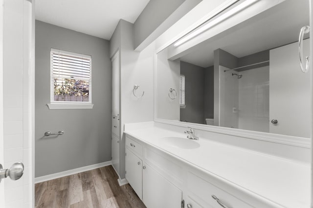 bathroom featuring wood-type flooring, vanity, and walk in shower