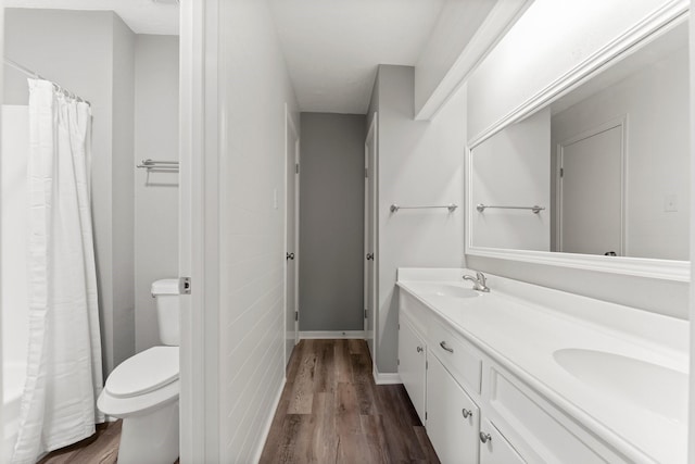 bathroom featuring hardwood / wood-style flooring, vanity, and toilet