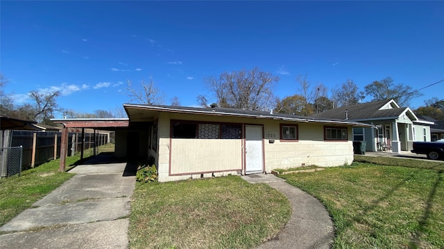 view of front facade with a front lawn and a carport