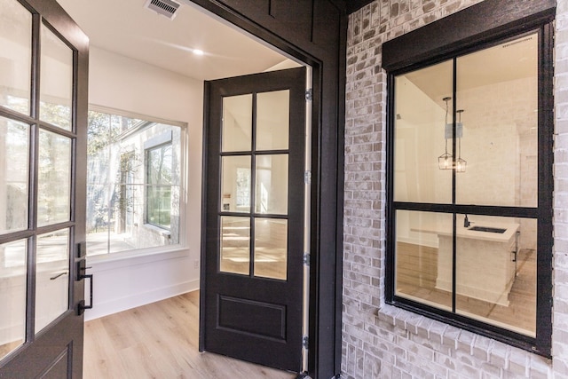 doorway with light hardwood / wood-style floors