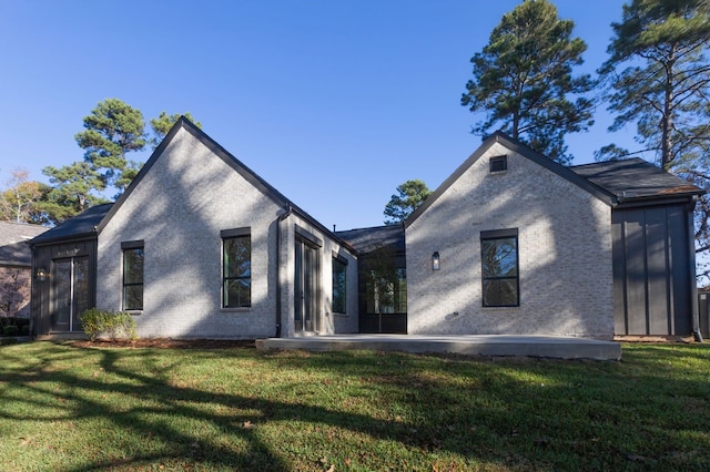 back of house with a lawn