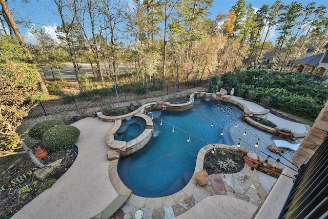 view of swimming pool with an in ground hot tub