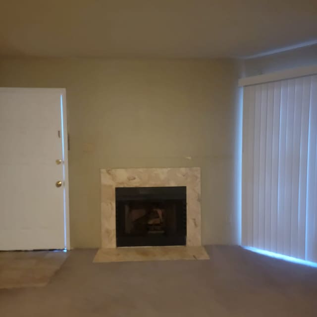 unfurnished living room featuring a premium fireplace