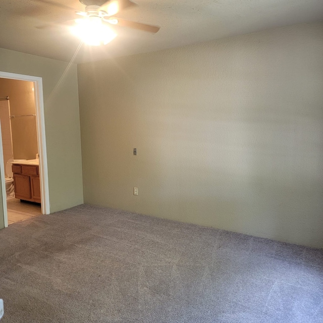 carpeted empty room with ceiling fan