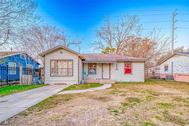 view of front of home featuring a front yard and cooling unit