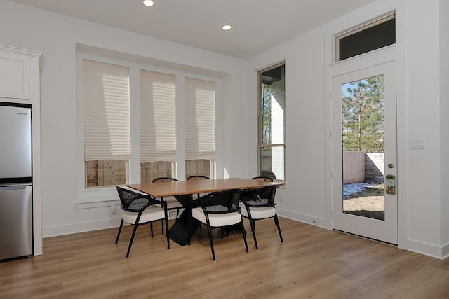 dining space with light hardwood / wood-style floors