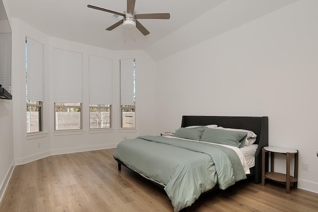 bedroom with vaulted ceiling, light wood-type flooring, and ceiling fan