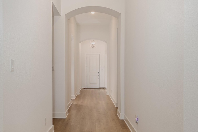 hallway with light hardwood / wood-style floors