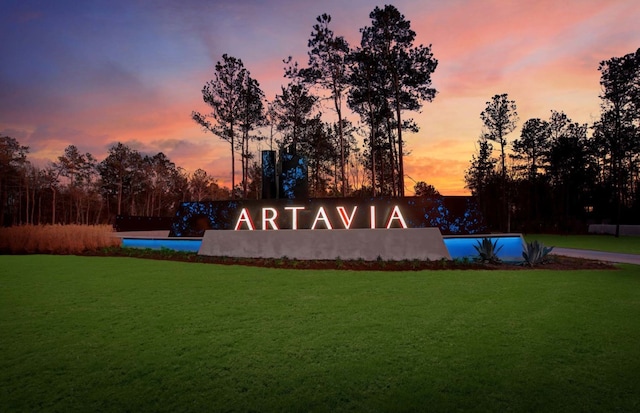 community sign featuring a lawn