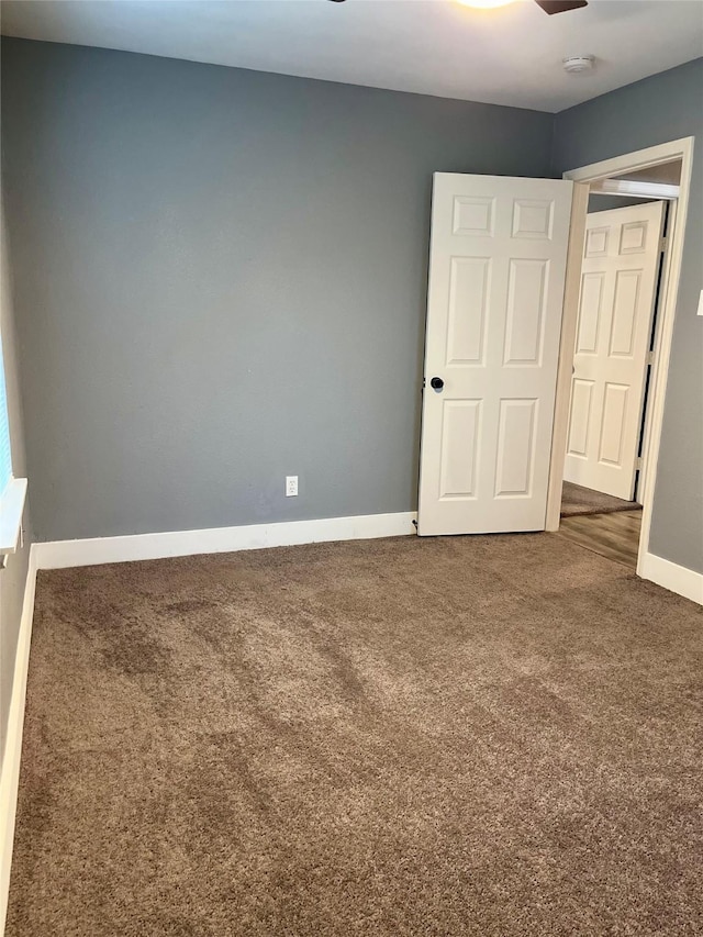 unfurnished room featuring carpet floors and ceiling fan