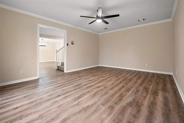 empty room with hardwood / wood-style flooring, ceiling fan with notable chandelier, and ornamental molding