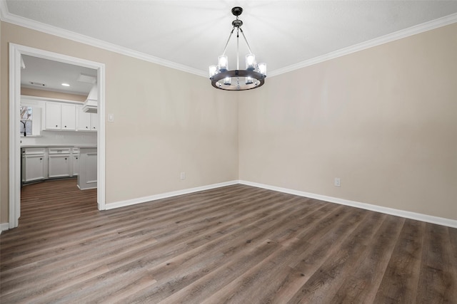 unfurnished dining area featuring crown molding, dark wood-type flooring, and a chandelier