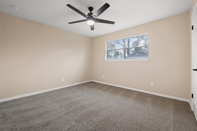 empty room featuring ceiling fan and carpet