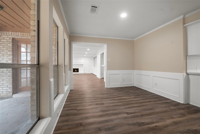 interior space with crown molding and dark hardwood / wood-style flooring