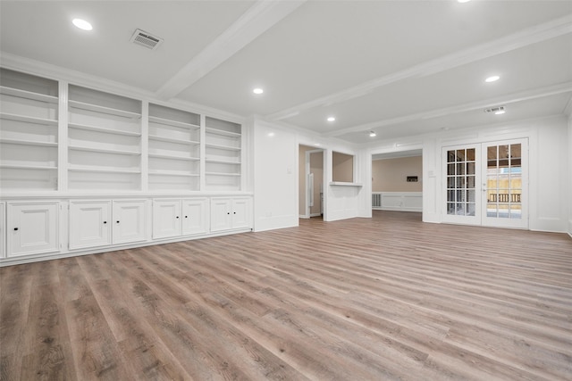 unfurnished living room with built in features, ornamental molding, beam ceiling, and light hardwood / wood-style flooring