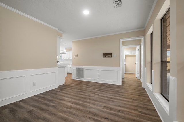 interior space featuring crown molding and dark hardwood / wood-style floors