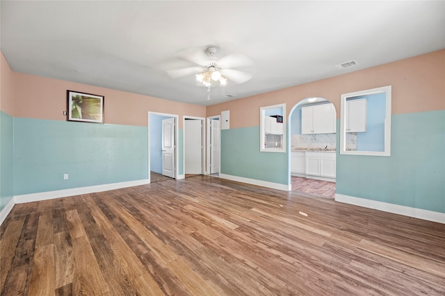 empty room featuring ceiling fan and light hardwood / wood-style floors