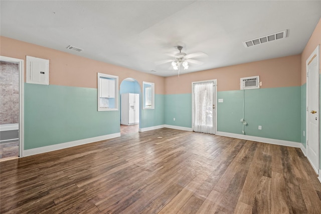 spare room with hardwood / wood-style floors, electric panel, and ceiling fan