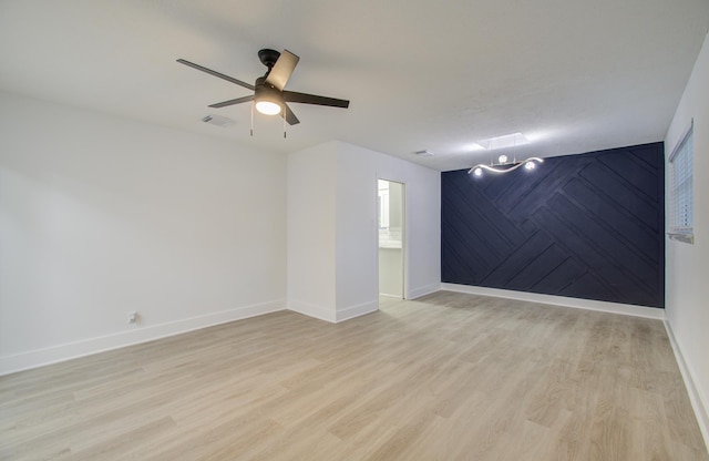 spare room featuring ceiling fan and light hardwood / wood-style floors