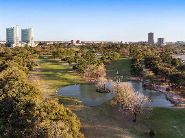 surrounding community with a water view and a yard