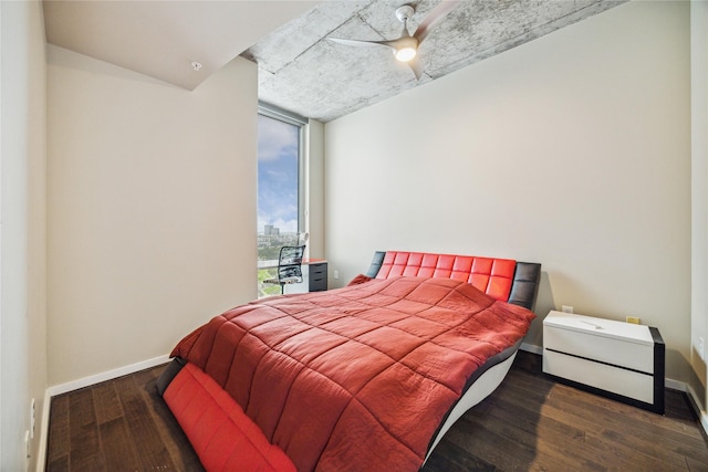 bedroom with dark hardwood / wood-style flooring and ceiling fan