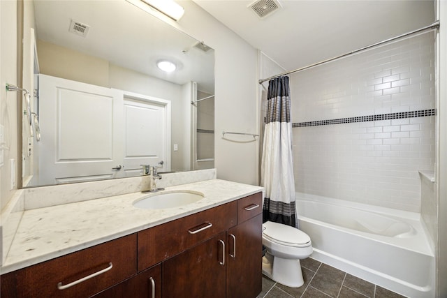 full bathroom with tile patterned floors, vanity, toilet, and shower / tub combo