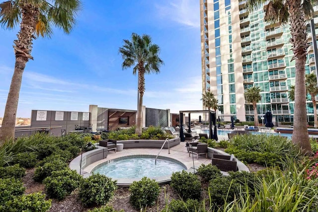 view of swimming pool with a community hot tub