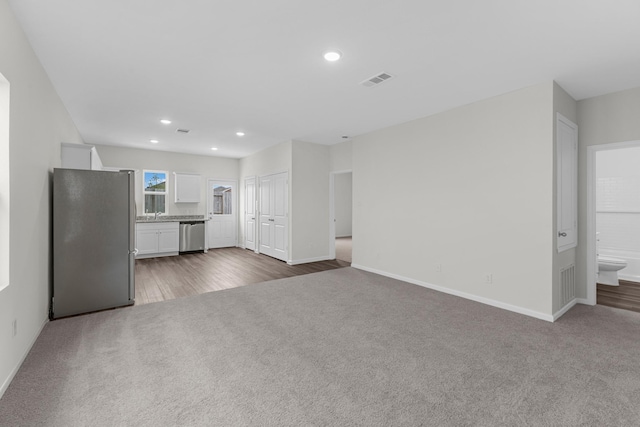 unfurnished living room with dark colored carpet