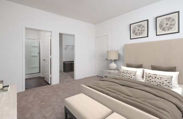 bedroom with a walk in closet, ensuite bathroom, carpet flooring, and a closet