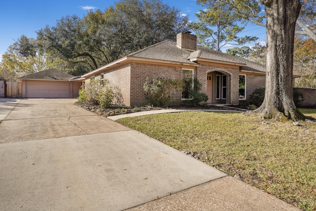 ranch-style house with a garage and a front lawn