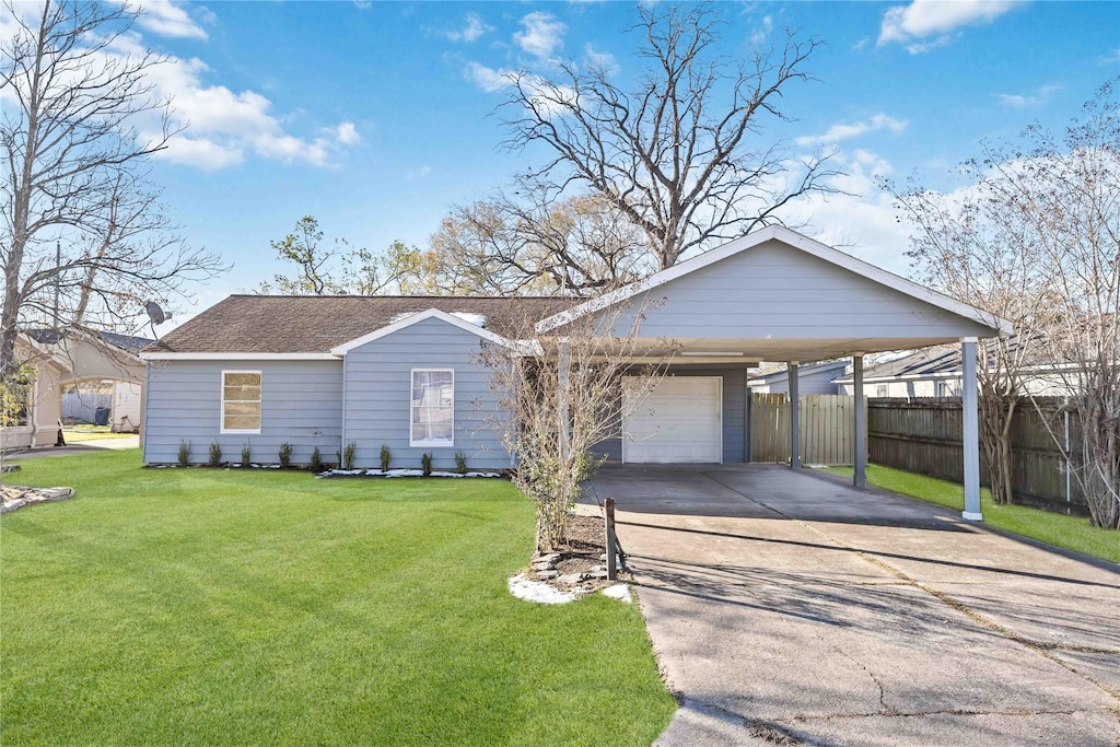 ranch-style home featuring a garage, a front yard, and a carport