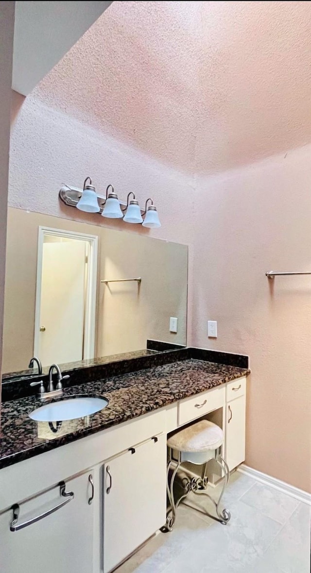 bathroom with vanity and a textured ceiling