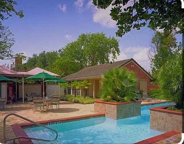 view of pool featuring a patio